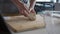 Woman kneading fresh dough at home in her kitchen, slow motion