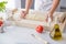 Woman kneading pizza dough on wooden pastry board