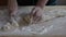 A woman kneads dough