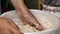 Woman kneads dough in a basin. For baking wholegrain bread.