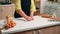 Woman kneads the dough on table