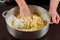 Woman kneads or mixing yeast dough for making buns