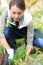 Woman kneeling in garden