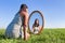 Woman kneeling on grass looking at mirror image