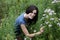 Woman kneeling in meadow