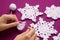 Woman knits crochet Christmas decoration â€“ snowflakes