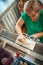 Woman knits on a knitting machine,