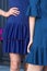 Woman in knitted blue dress. Two girl wear skirts. Classic blue color 2020