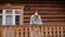 woman in a knitted red hat and scarf drinks hot tea standing