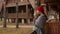 woman in a knitted red hat and scarf drinks hot tea standing