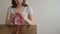 Woman knitting at a wooden table