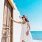 Woman knocking on the door of a beach home in Greece