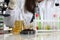 Woman in laboratory drips into soil with sprout