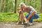 Woman with labrador retriever in forest