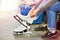 Woman laces figure skates in sports shop