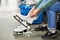 Woman laces figure skates in sports shop