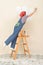 Woman on Ladder Painting