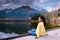 Woman by the lake watching sunset, Pyramid lake Jasper during autumn in Alberta Canada, fall colors by the lake during