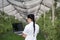 Woman with laptop in apple orchard