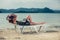 Woman with laptop on beach