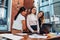 Woman with laptop colleagues standing in office