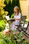 Woman with laptop in garden