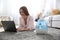 Woman with laptop near modern air humidifier