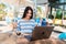 Woman with laptop pumping fists happy laughing online lottery winner. . Girl with long hair sitting outdoors on a coffee shop