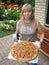 Woman with large pizza on tray