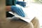 Woman in latex gloves cleaning laptop with wet wipe, closeup