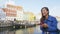 Woman laughing at Copenhagen Nyhavn using Phone