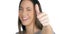 Woman laughing gesturing thumb up on white background