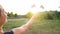 Woman launches paper airplane against sunset background. Concept of dreaming about traveling or the profession of a