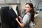 Woman laundry office worker adjusting jacket on mannequin