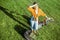 Woman with lawn mower on the backyard