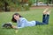 Woman layed on grass reading magazine