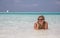 Woman is laying in blue waters of Indian ocean and speaking by telephone