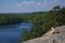 Woman laying on cliff an relaxing above the lake Yastrebinoye, Priozersky district in Leningrad region, Russia