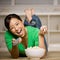 Woman laying on floor with bowl of popcorn