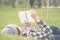 Woman laying and lookin book in a park