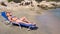 Woman laying in sunbed on beach