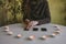 Woman lays out black cards on the table with candle lights