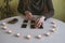 woman lays out black cards on the table with candle lights