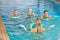 Woman leading aqua fitness class