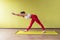 A woman leading a healthy lifestyle performs a torso forward tilt with outstretched arms