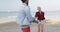 Woman Leading Man Couple Running On Beach Holding Hands Young Happy Tourists On Vacation