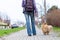 Woman leads her dog on a leash