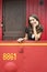 Woman Leaning On Railing In Red Train Caboose Car