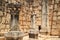 Woman leans in doorway of basalt brick wall in the ancient ruins of Capernaum