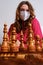 Woman learning chess in quarantine, self-study board game at home